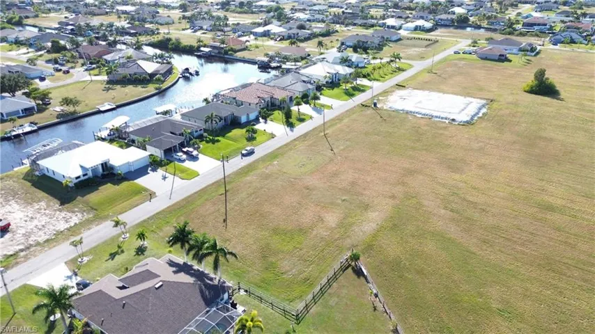 Aerial view of residential area featuring a large body of water