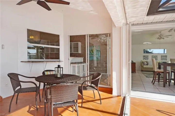 View of patio featuring outdoor dining space and ceiling fan.  Morning coffee?  Evening wine???