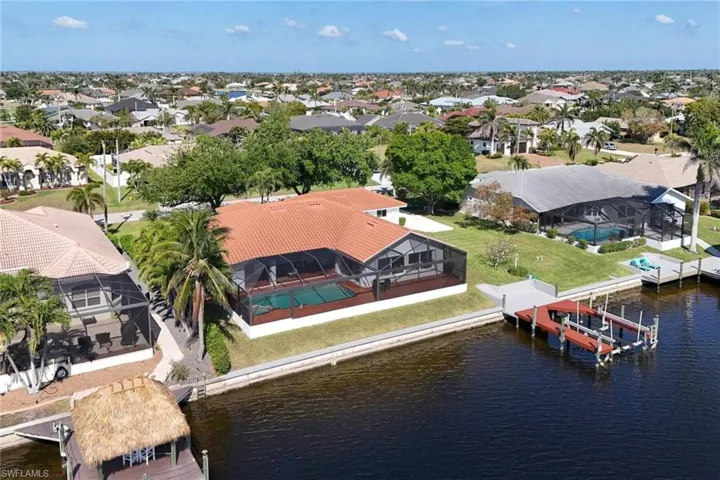 Bird's eye view featuring a residential view and a water view. New beautiful tile roof in 2019.  Dock with lift ready for you to park your new boat.  No waiting for permits for a dock.