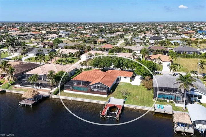 Drone / aerial view featuring a residential view and a water view. Rare 3 lot site on wide intersecting canals.