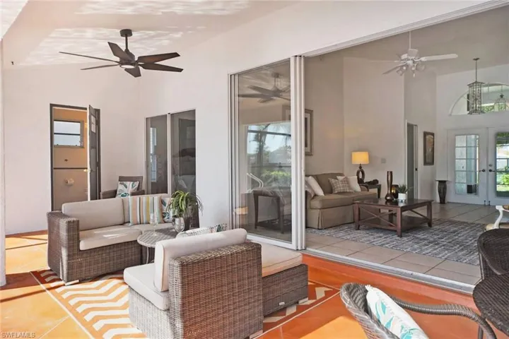 View of patio with French doors, a ceiling fan, and outdoor lounge area.  Step out to the lanai with the pool, spa and  full bath