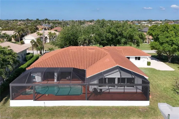 Aerial view  Back of house showing beautiful picture window screen on the lanai.  Huge extended lanai for sunbathing and entertaining.
