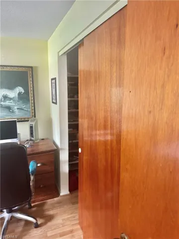 Office with light wood finished floors and a textured ceiling