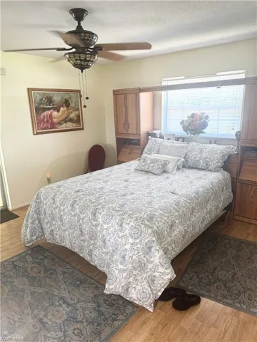 Bedroom with wood finished floors and a ceiling fan