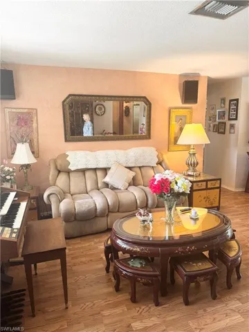 Living area with wood finished floors and a textured ceiling