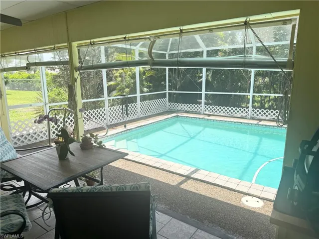 Outdoor pool with glass enclosure and a patio area