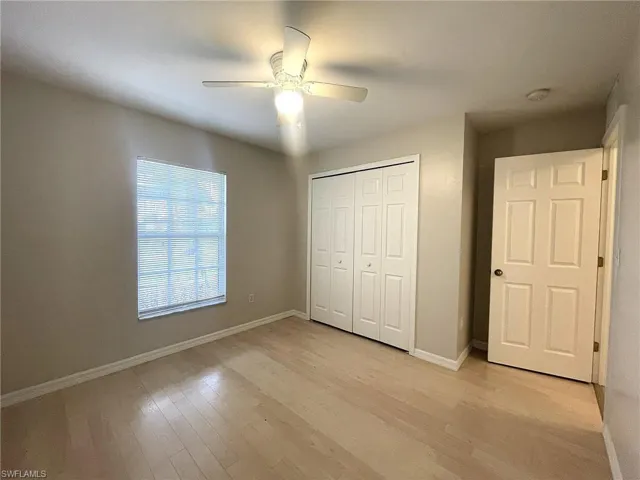 Unfurnished bedroom with light hardwood / wood-style flooring, a closet, and ceiling fan
