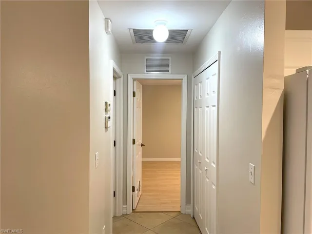Hallway with light tile patterned flooring