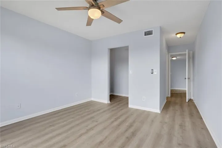 Unfurnished bedroom with ceiling fan and light wood-style floors