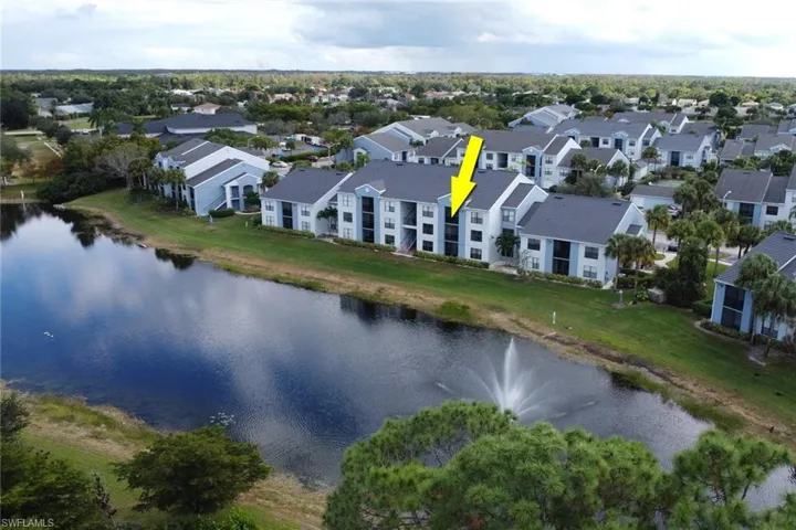 Aerial perspective of suburban area featuring a nearby body of water