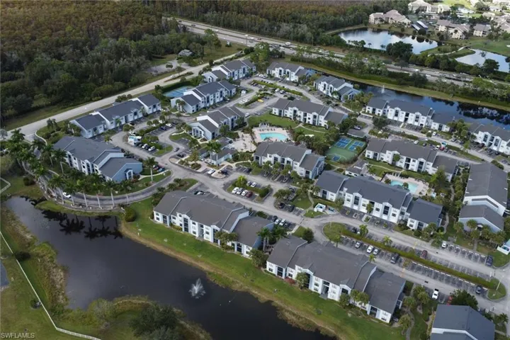 Aerial view of property and surrounding area featuring a nearby body of water