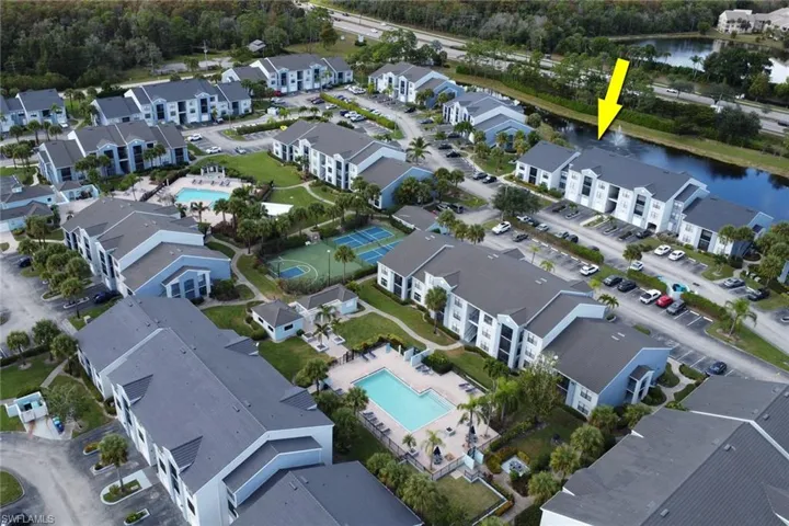 View of property location featuring a pool and a nearby body of water