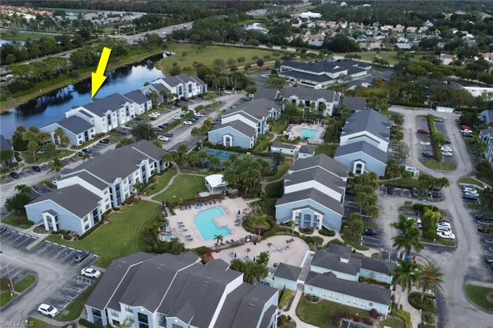 Aerial overview of property's location featuring a pool area and a large body of water
