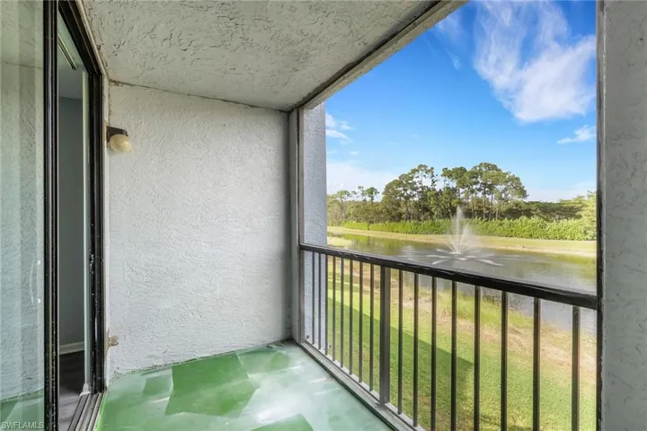 Balcony featuring a water view and a sunroom