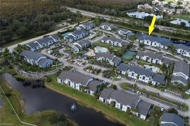 Aerial view of property and surrounding area featuring a large body of water