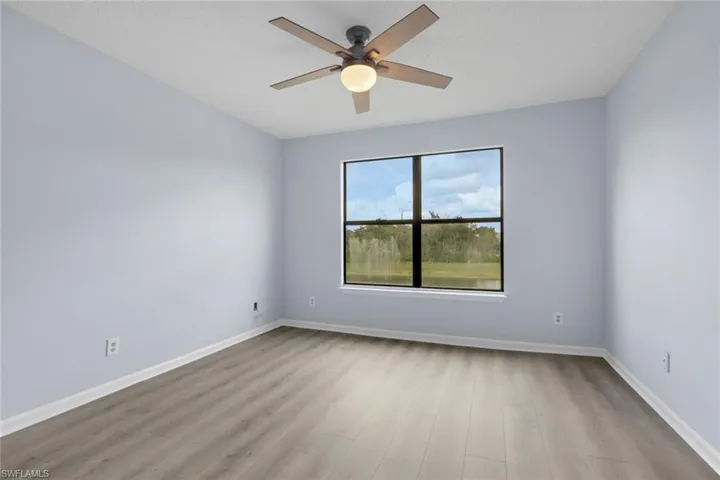 Spare room with light wood-style flooring, ceiling fan, and a textured ceiling