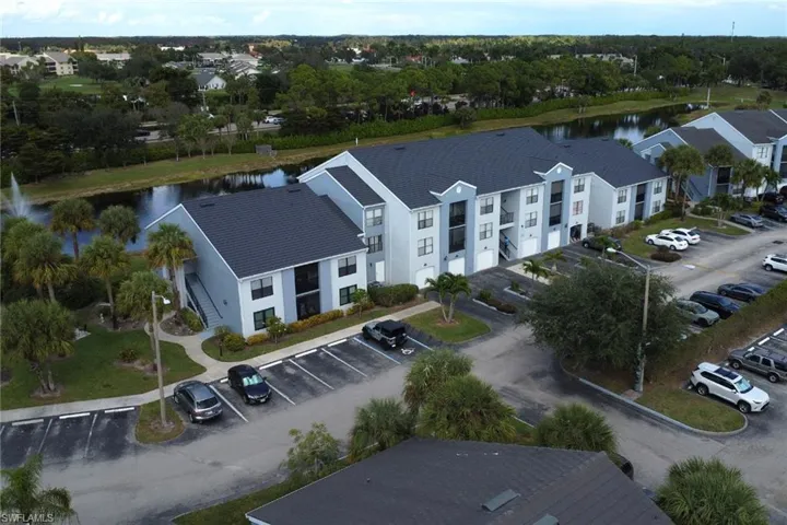 Drone / aerial view of a large body of water and apartment complex