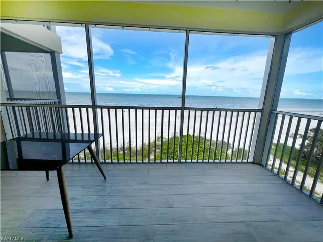 Unfurnished sunroom with a water view