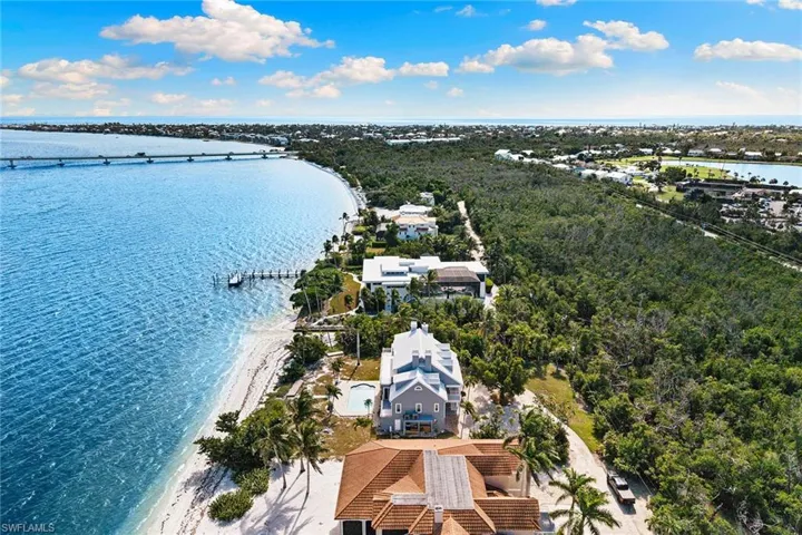 Aerial view of a nearby body of water and a notable bridge