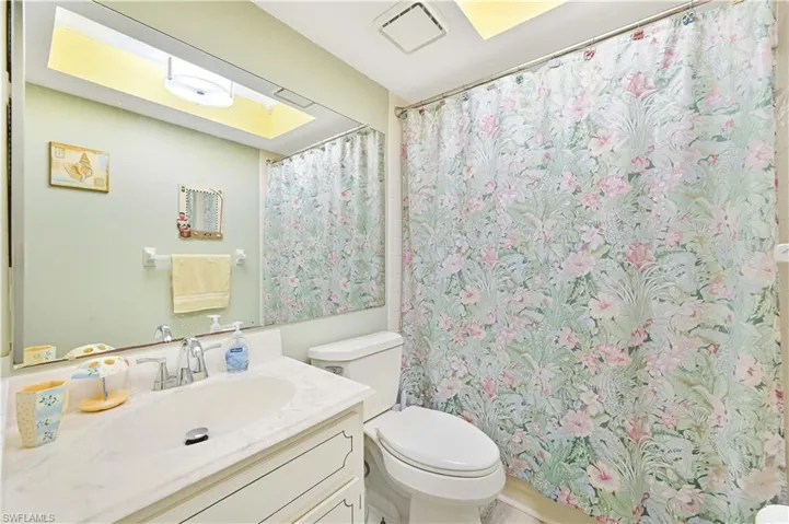 Full bathroom with vanity and curtained shower