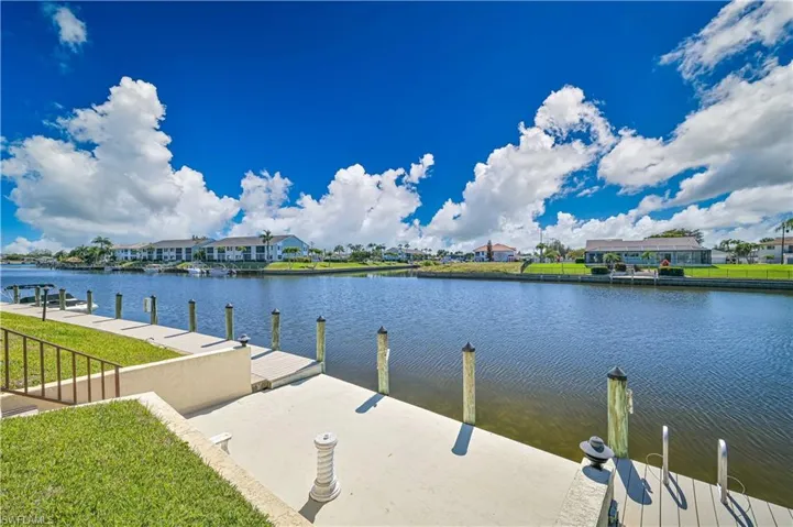 Dock featuring a residential view, a water view, and a yard