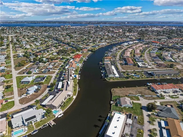 Aerial perspective of suburban area featuring a large body of water