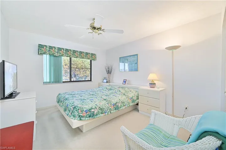 Bedroom featuring light carpet and ceiling fan
