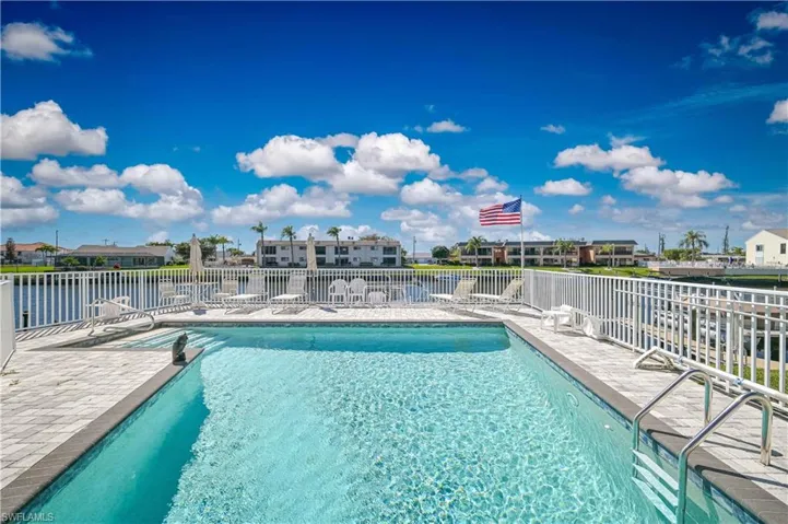 Community pool with a residential view and a patio