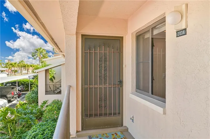 Entrance to property with stucco siding
