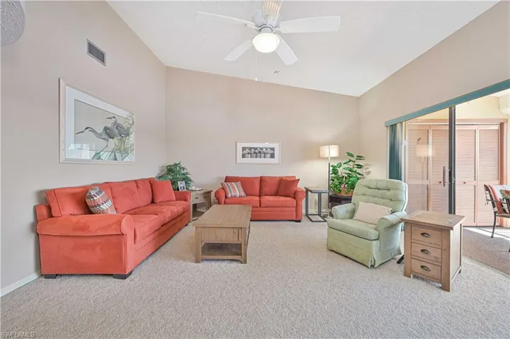 Living room with a ceiling fan and carpet