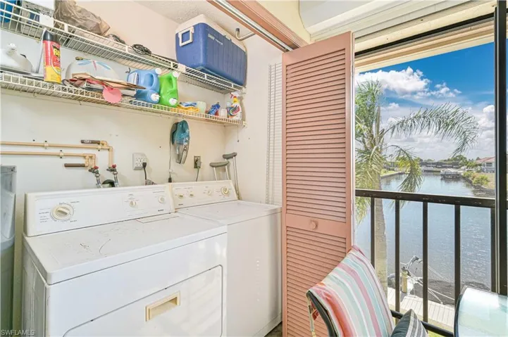 Laundry area with separate washer and dryer and a water view