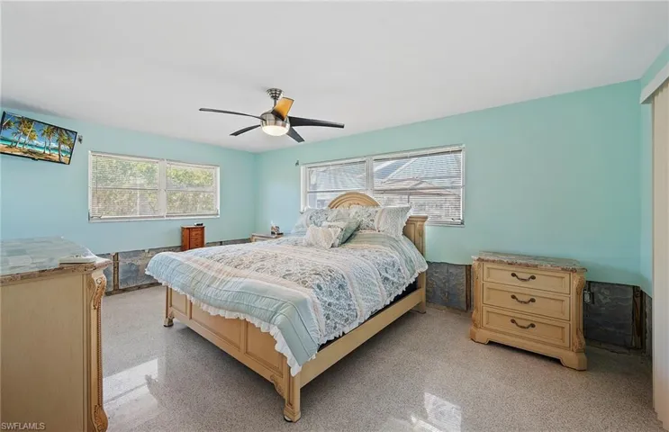 Bedroom with multiple windows and ceiling fan