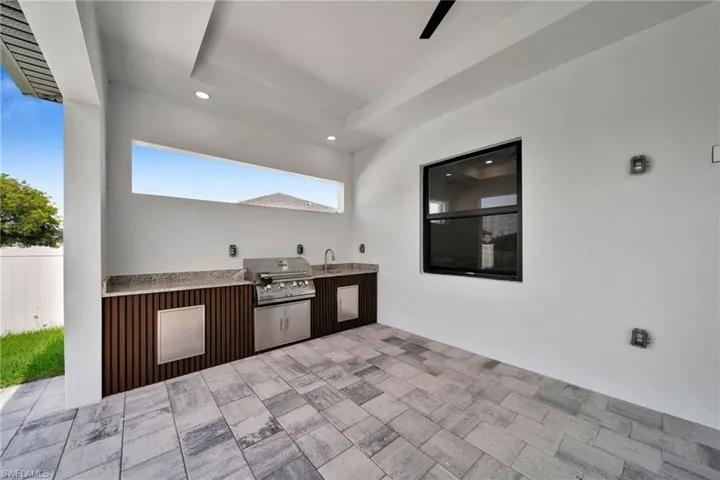 View of patio with sink and area for grilling
