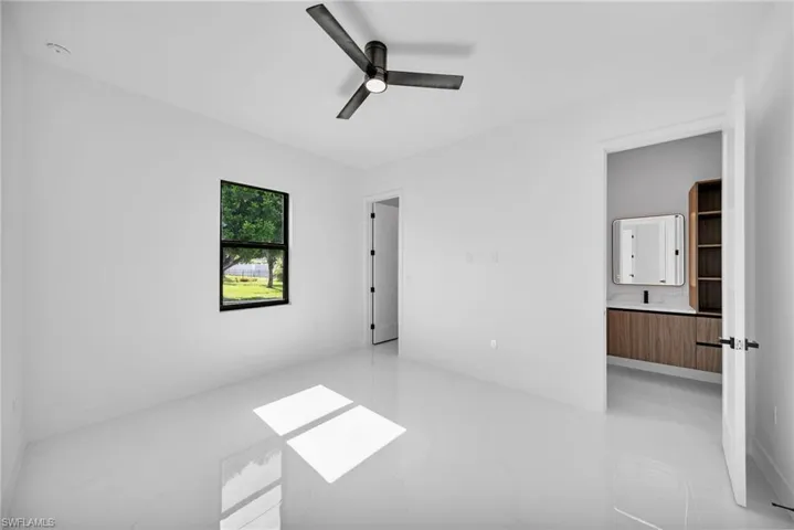 Spare room with light tile patterned floors and ceiling fan
