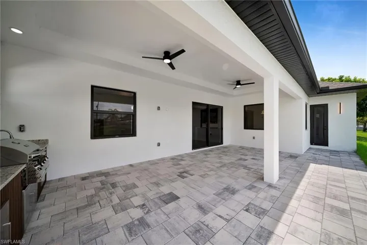 View of patio featuring area for grilling and ceiling fan