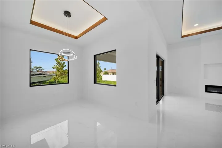 Tiled spare room with a raised ceiling