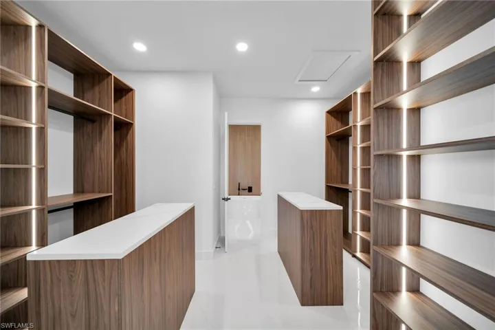 Spacious closet with light tile patterned floors
