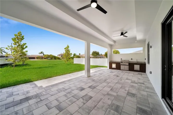 View of patio / terrace with grilling area, an outdoor kitchen, and ceiling fan