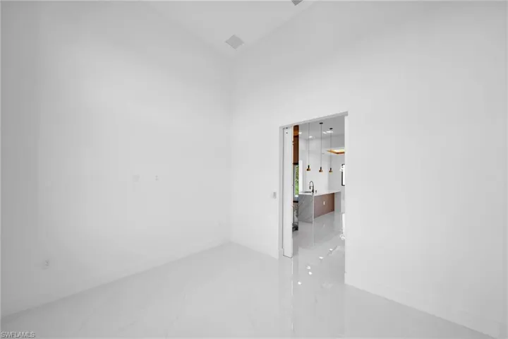 Tiled spare room with a towering ceiling