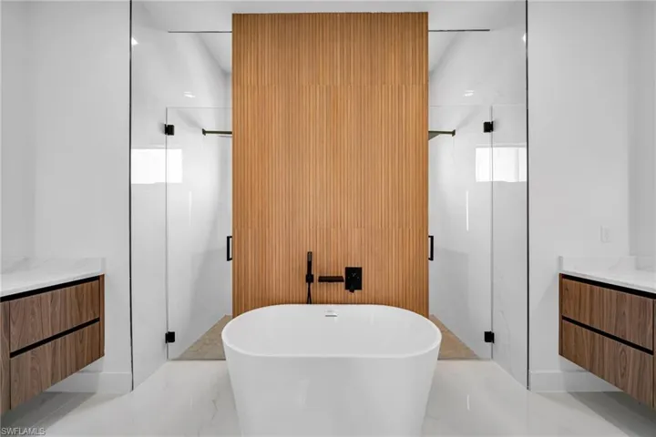 Bathroom with independent shower and bath, vanity, and tile patterned flooring