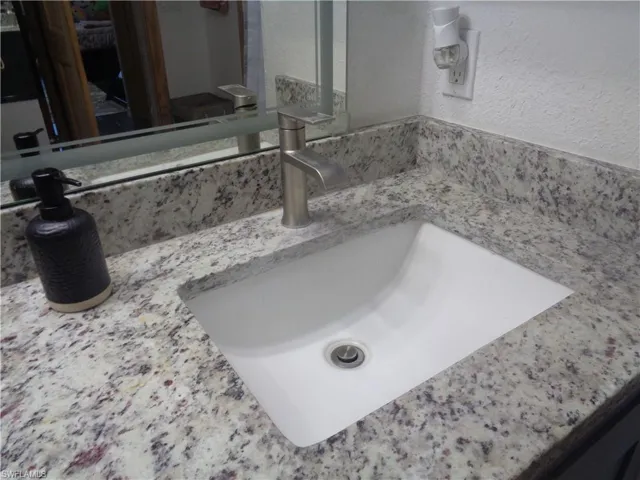 Master bedroom's bathroom featuring granite top and t vanity