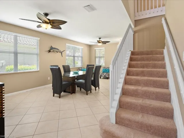 Tiled dining space with ceiling fan