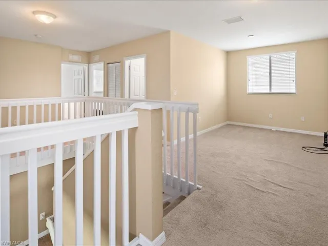 Hallway featuring carpet