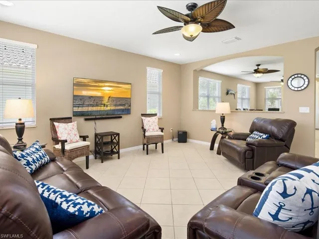 Living room featuring ceiling fan and light tile floors