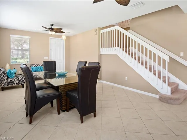 Dining room with ceiling fan and light tile flooring