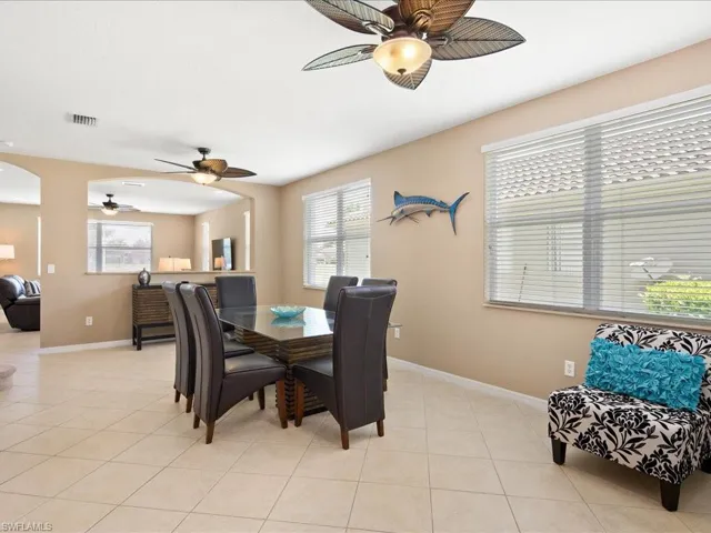 Dining room with light tile flooring and ceiling fan
