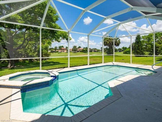 View of pool featuring a lanai, an in ground hot tub, and a yard