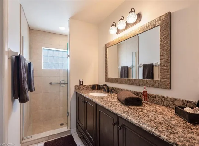 Easy care granite countertop in primary bath.