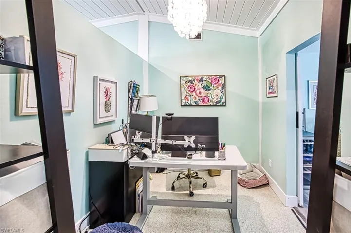Home office featuring a notable chandelier, wooden ceiling, ornamental molding, and vaulted ceiling