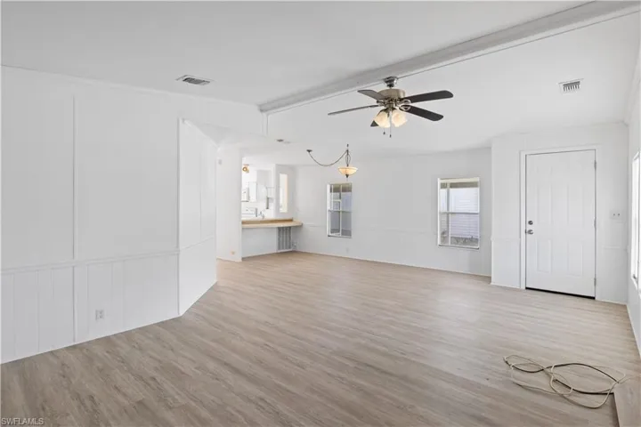 Inviting entrance opens into a bright, open living space with high ceilings and abundant natural light.